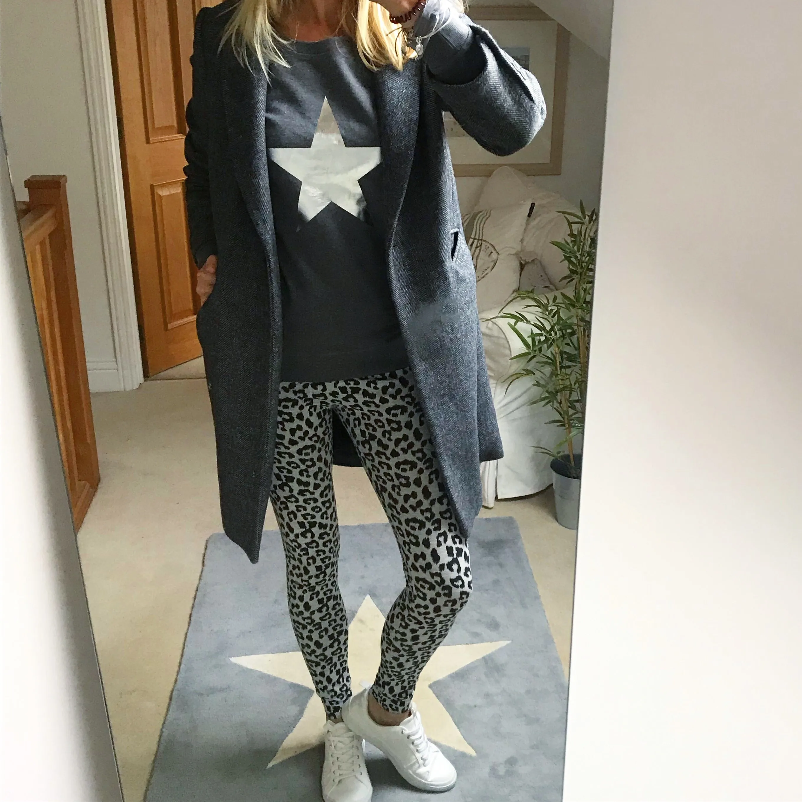 Metallic silver star on a dark grey sweatshirt